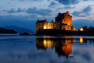 Illuminated Eilean Donan Castle at night in the Scottish Highlands