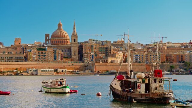 View of Valletta's of Capital City of Malta at sunny day. Marsamxett Harbour with the view on Valletta Saint Paul's Anglican Cathedral