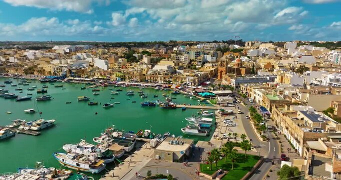 Aerial view of the Port of Marsaxlokk In Malta. A small fishing village with traditional colorful boats