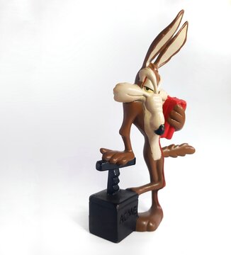 Vintage collectible PVC figurines, Looney Tunes Coyote characters Wile E with a plunger and a dynamite marked ACME.