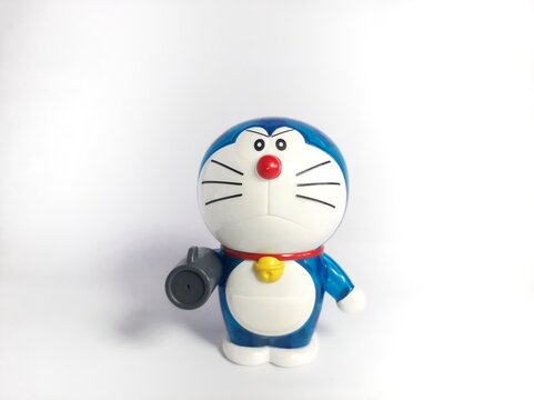 figurine Doraemon with air canon gadget on a white background