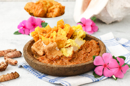 Indonesian street food batagor from Bandung, made with fried fish dumplings and tofu, served with rich peanut sauce. 