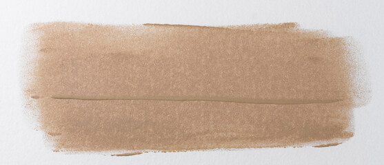 Fototapeta premium Broad brushstroke of nude or beige foundation with a distinct wave texture from the brush, glossy finish, close-up on a white background