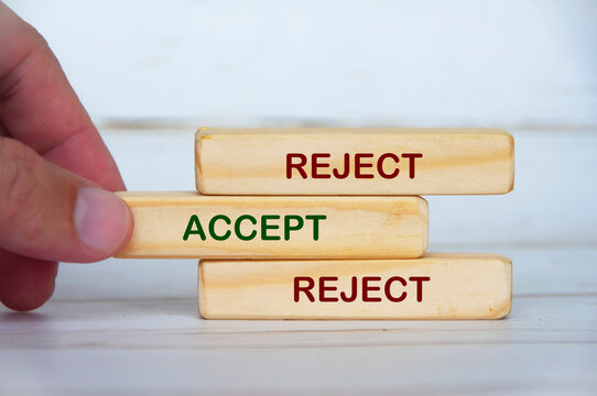 Reject Accept Reject text on wooden blocks symbolizing reconsideration and balanced judgment before final decisions.