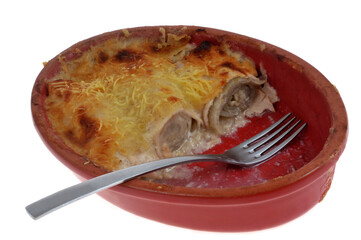 Plat d'endives au jambon gratin&eacute;es fait maison entam&eacute; avec une fourchette en gros plan isol&eacute; sur fond blanc