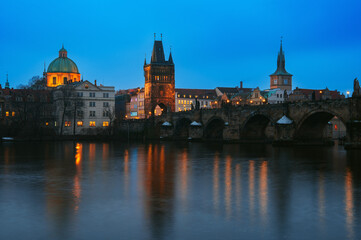 Fototapeta premium Charles Bridge (Karlův most) at Blue Hour, Prague, Czech Republic. Night Cityscape with Reflections