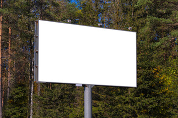 Fototapeta premium Advertising billboard along the road in the city on a sunny day. Background for design.