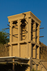 Views of Oriental buildings, sandstone walls and arches, windows and doors. On the streets of Dubai, in a public place.