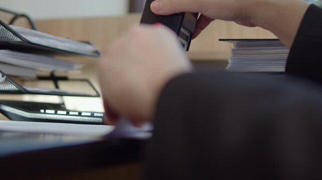 Hand stamping document on office desk