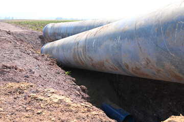 Large pipeline pipeline construction industrial pipe underground pipeline trench soil rural landscape infrastructure metal pipe agriculture field pipeline construction large pipeline industrial