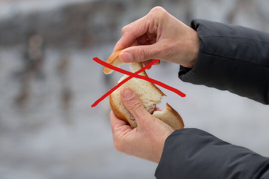 Girl feeding ducks bread in winter.The concept of the negative impact of bread on the health of wild ducks.