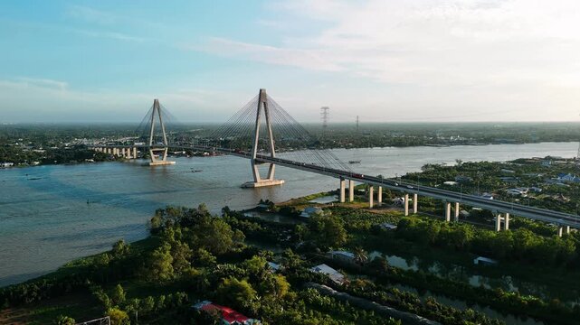 Aerial view of can tho bridge crossing the hau river at sunset, showcasing modern infrastructure and transportation in vietnam