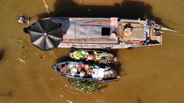 Traditional floating market on the mekong river in vietnam with people trading on boats, cai rang floating market an aerial view