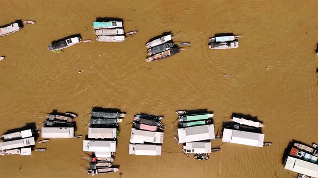 Aerial view of cai rang floating market in vietnam with many traditional boats trading on the muddy mekong river delta, can tho
