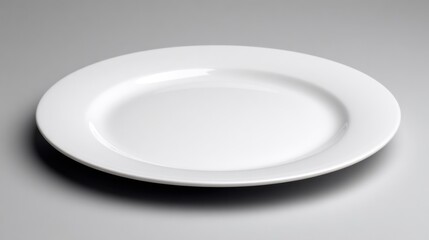 Clean white plate isolated on a gray background for culinary and design uses