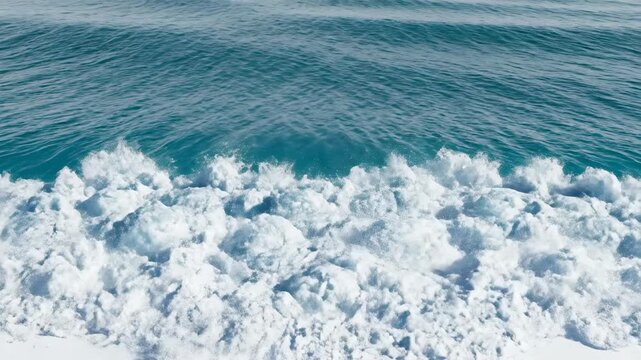 Simulated overhead zenith view of a perfectly formed teal wave line rolling and breaking in isolation above a white studio floor power, aqua, studio environment