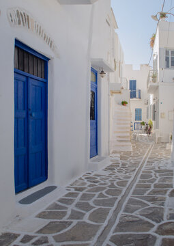 
Typical white-washed street with blue doors and shutters in Parikia Old Town on the Greek island of Paros.