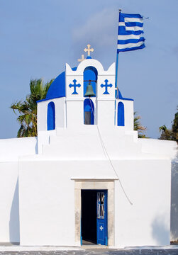 Church of Agios Nikolaos Thalassitis in Parikia, Paros, Greece with Greek Flag