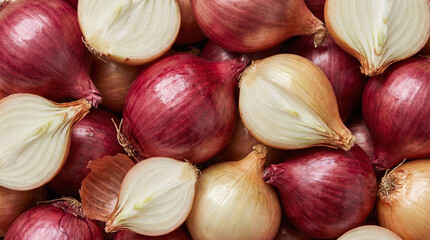 Close-up overhead view of fresh red and yellow onions, some halved