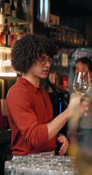 Barman, wine tasting and guide with smell at restaurant for vintage, flavor profile and test. Person, bartender and discussion with alcohol, drinks and social event at bar with customer experience