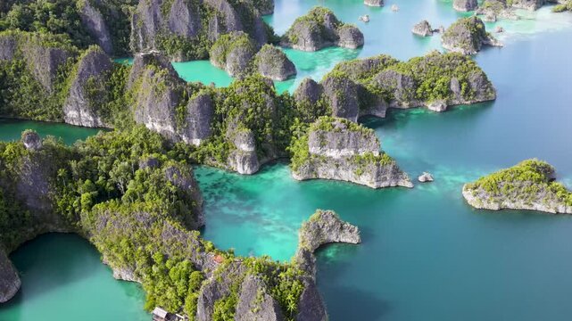 Aerial view of the turquoise Star Lagoon with green rocky hills, Piaynemo, Raja Ampat, Indonesia in 4K