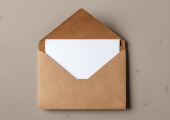 A brown paper envelope, open, revealing a white card against a neutral background