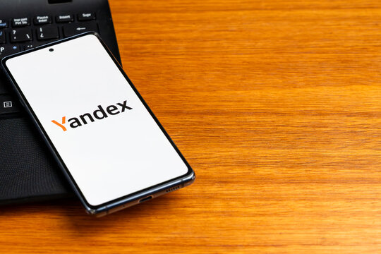 Punta Arenas, Chile &ndash; February 23, 2026: The Yandex search engine logo displayed on a smartphone screen resting on a black laptop keyboard