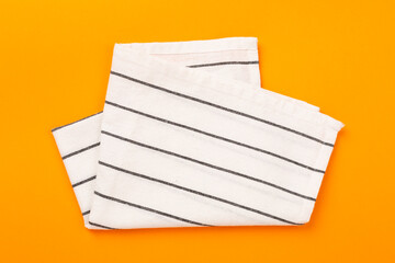 Kitchen napkin on color background, top view