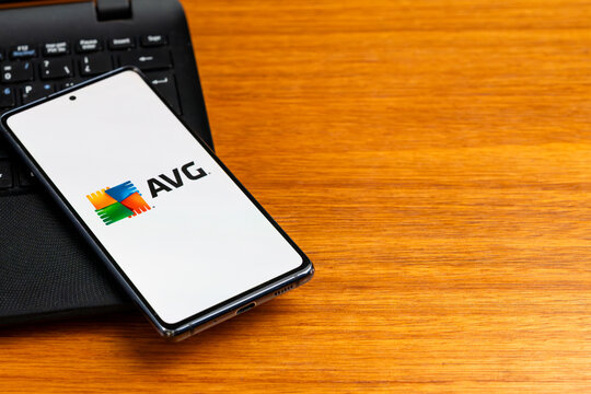 Punta Arenas, Chile &ndash; February 23, 2026: The AVG Antivirus logo, featuring its four-color square emblem, displayed on a smartphone screen resting on a laptop keyboard