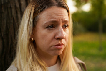 Fototapeta premium Sad emotional woman on the verge of tiers closeup shot 