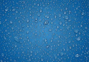 A close-up view of numerous water droplets forming on a blue surface