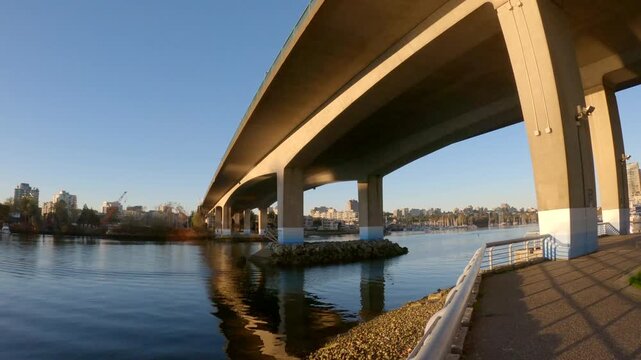 Cambie Bridge False Creek Dawn Crossing Vancouver 4K UHD.A gimbal shot looking up at the Cambie Bridge over False Creek in the morning. Vancouver, British Columbia.
