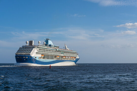 Close view of a large cruise ship leaving port in the Caribbean Sea. Sunny day, blue sky. Space for copy. Havana, Cuba.
