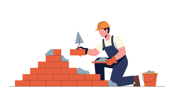 A construction worker kneels on the ground, laying bricks with a trowel to build a masonry wall.