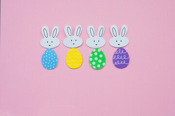Colorful Easter Bunnies with Decorated Egg Bodies on Pink Background