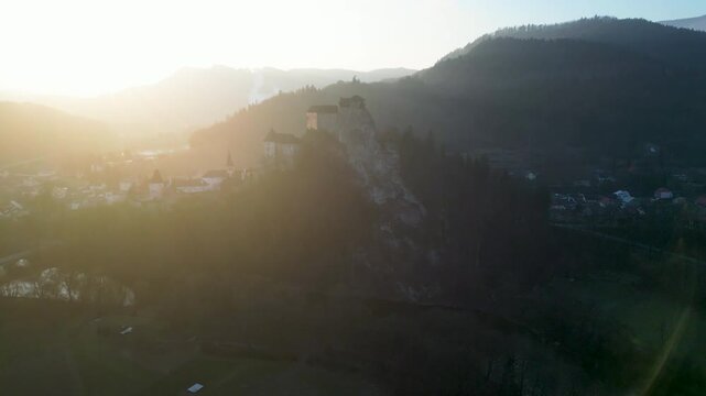 Aerial view Orava Castle above the river in sunset light. landscape, 4K, ProRes