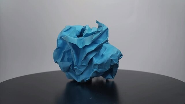 close up of a vibrant crumpled paper ball, symbolizing a discarded idea, mistake, or creative block.