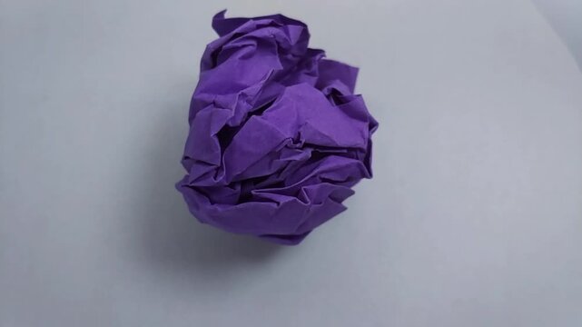 close up of a vibrant crumpled paper ball, symbolizing a discarded idea, mistake, or creative block.