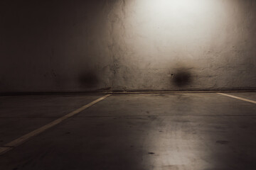 Empty parking lot with overhead dim light © Vlad Ispas