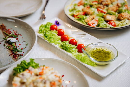 Fresh vegetable appetizer with cherry tomatoes, lettuce and green herb dressing