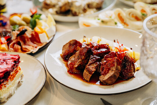 Roasted meat with sauce served on festive gourmet restaurant dinner table
