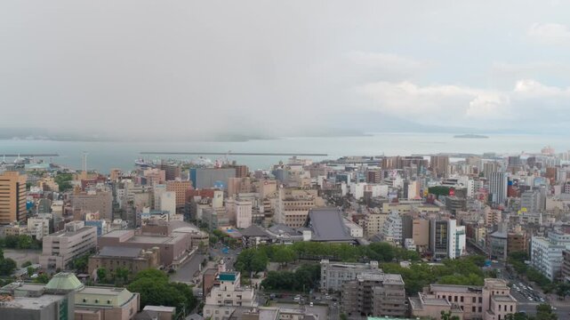 Kagoshima, Japan. View of  Kagoshima city in Japan during a cloudy day. Time-lapse with moving clouds