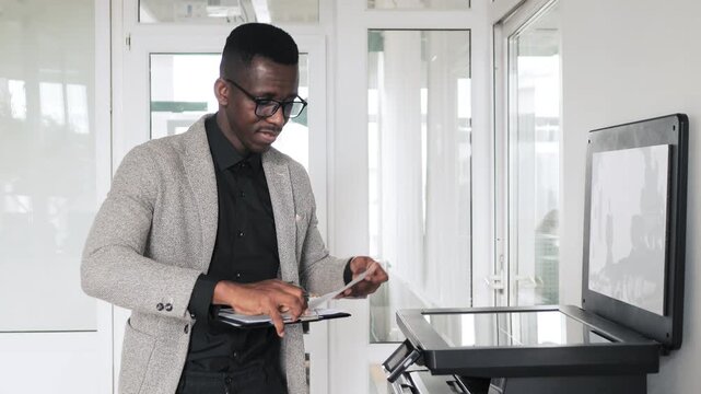 African american businessman scanning documents at the office