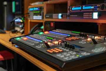 Professional video control room with broadcast equipment and mixing console