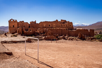 Ruins of Telouet Kasbah with desert soccer field, Morocco. © tabaro