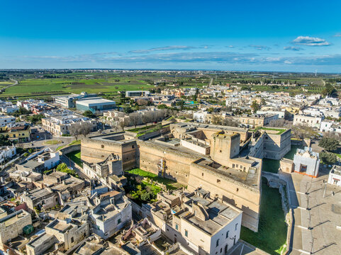 Aerial view of Copertino castle, massive Renaissance fortress features a striking quadrangular plan anchored by four spearhead-shaped bastions and imposing scarp walls
