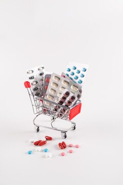 Shopping cart filled with various blister packs of pills