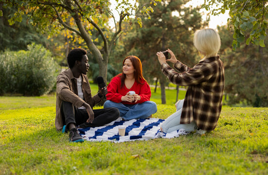 Friends enjoying an interview at sunset in the park