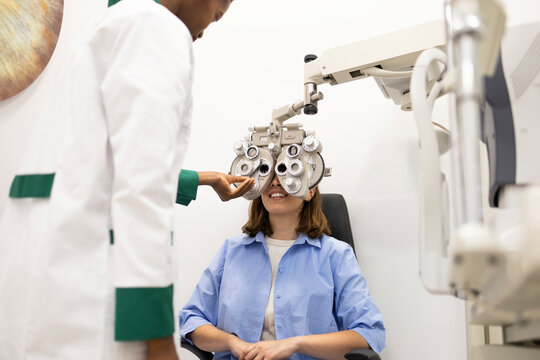 Eye examination with optician using phoropter machine
