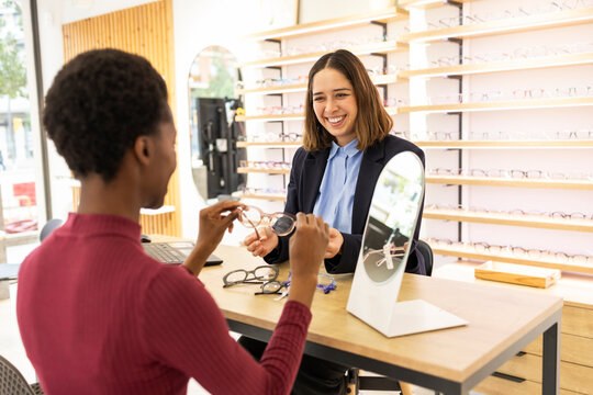 Customer choosing glasses in a modern optical store